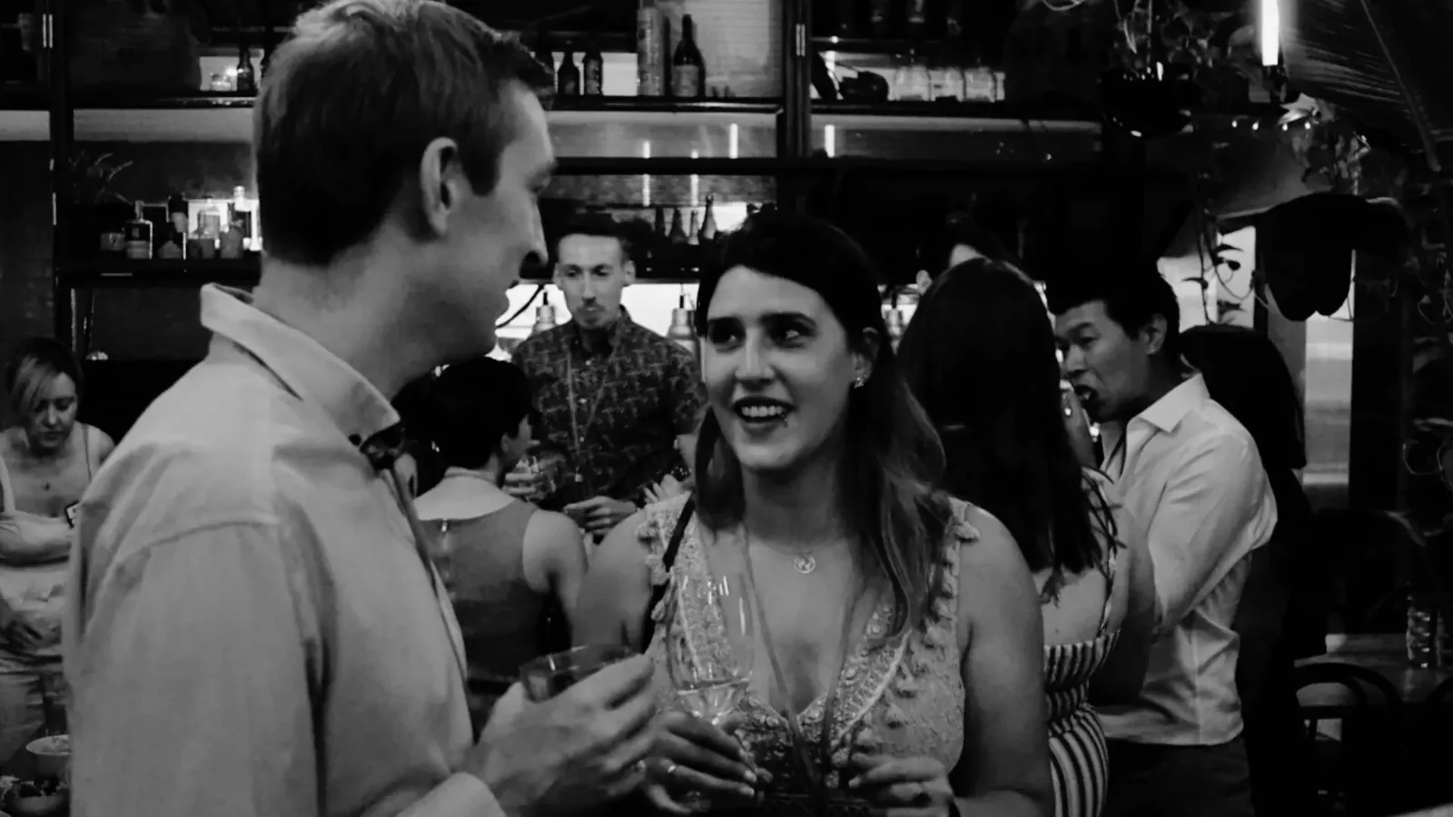 Two guests in conversation at the bar