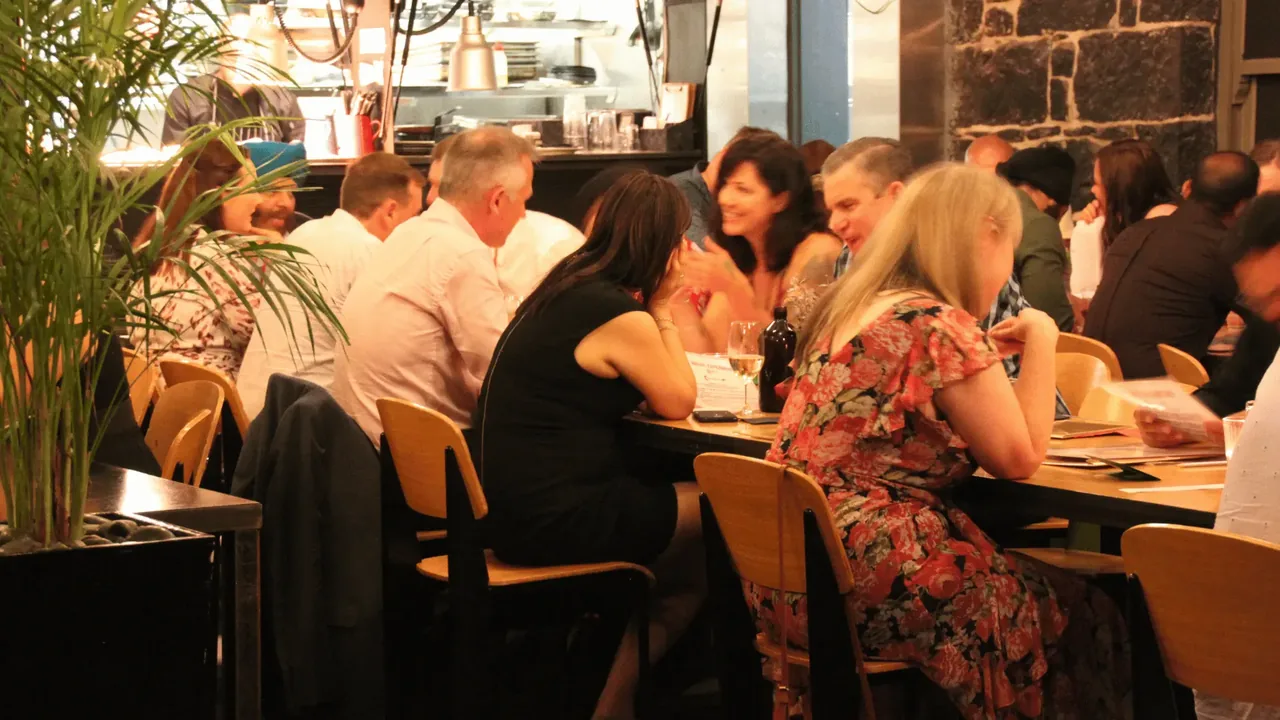 Guests mingling in a warm, candle-lit room
