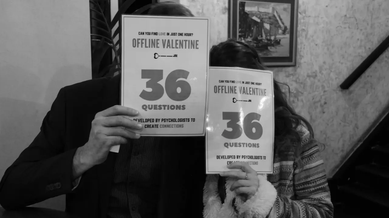 Guests holding up the 36 Questions cards